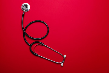 Stethoscope on color background. Cardiology concept