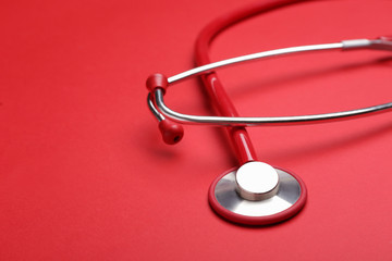Stethoscope on color background. Cardiology concept