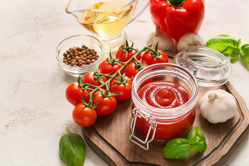 Tomato sauce with ingredients on white background