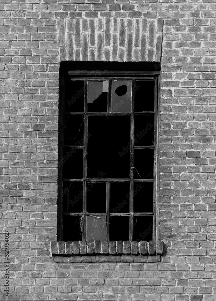 Poster grey-scale shot of the broken windows of an old building
