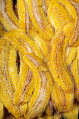 Bright yellow candied banana slices close up