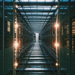 Vertical shot of an illuminated data center storage and network server room