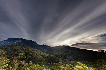 Sunrise at the Mount Kinabalu, Borneo, Sabah, Malaysia. The sun comes up behind the highest mountain in South east Asia, the mount kinabalu. Near the city of Kota Kinabalu. Colorful clouds at the sky
