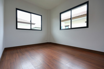 interior design empty white room with glass window and wooden laminate floor of a new residential house