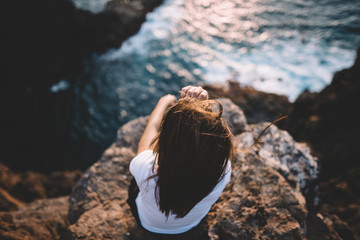 Woman thinking in a hill with views at ocean