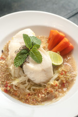 Seabass fish fillet steak on spicy seafood thai style sauce