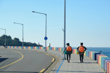 Haenyeo walking on the sea and beautiful streets of Jeju. Jeju Island.