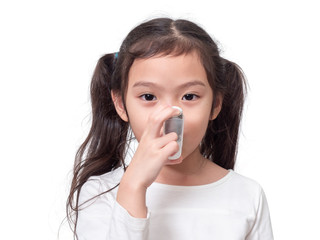 Asian little cute girl 6 years old using asthma inhaler on white background.