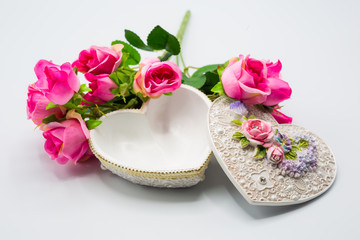 Fototapeta na wymiar Opened empty heart shape box with decoration bouquet of roses on white background for Happy Valentine's Day