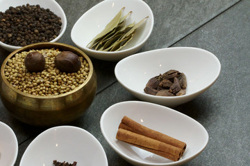 Bowls with whole Indian aromatic spices filling the frame.