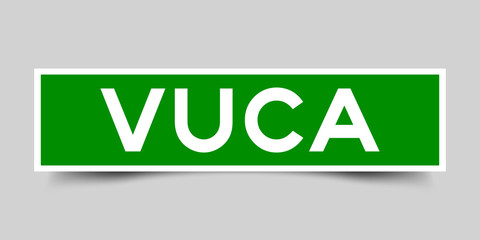 Label square green sticker in word VUCA (abbreviation of Volatility, uncertainty, complexity and ambiguity) on gray background (vector)
