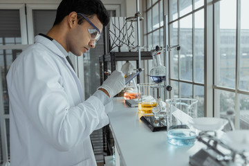 Young male scientists conducting research in modern biological laboratory.