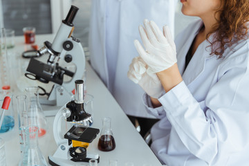 Scientist wearing a medical glove in modern biological laboratory.