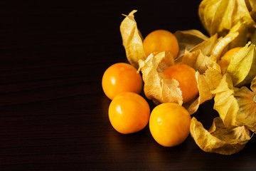 Cape gooseberry on a dark wooden background