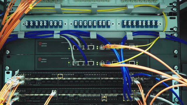 A working server. Internet wires and flashing lights on the server.