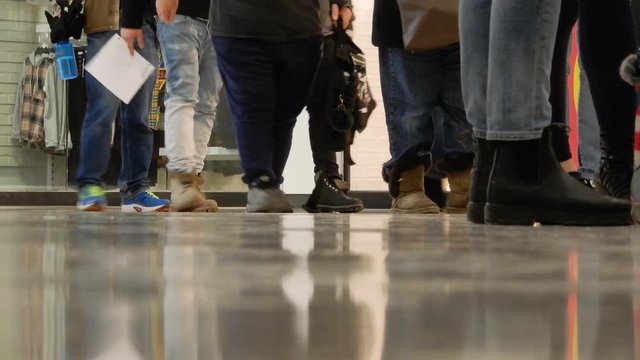 Lines of People Walking Standing in Line for a Job Application Resume Employment Economy With White Sheets of Paper