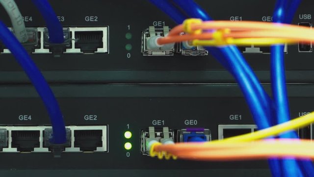 A working server. Internet wires and flashing lights on the server.