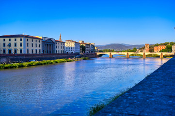 Fototapeta na wymiar A view along the Arno River in Florence, Italy.