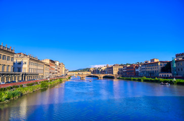 Fototapeta na wymiar A view of the Arno River towards the Ponte Vecchio in Florence, Italy.