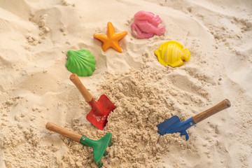 Fototapeta na wymiar Plastic children toys in sandpit outdoor.