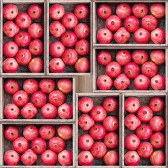 Composition of rustic wooden boxes with red pomegranates