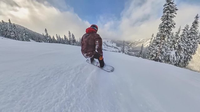 Man snowboarding down a mountain slope