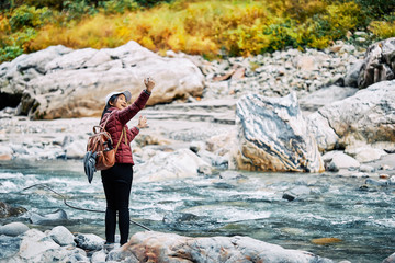 Asian women is selfie photographing at Kourobe Gorge, Toyama, Japan.