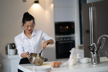 The action of the woman making the bread