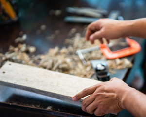 Woodworker in the shop. Carpenter making a pieces for woodturning project. Making a handmade project. Craftsman skills concept.