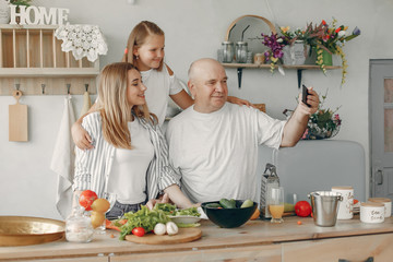 Family in a kitchen. Grandparents with grandchildren. People with vegetables
