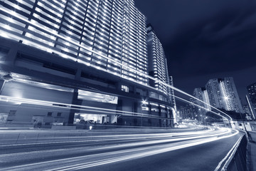 Fototapeta na wymiar traffic and high rise residential building in downtown of Hong Kong city at night