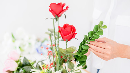 Flower shop staff arrange flowers as ordered for valentines.