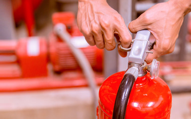 Close up Fire extinguisher and pulling pin on red tank.