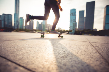 Skateboarder skateboarding at sunset city