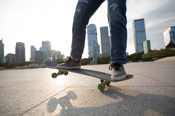 Skateboarder skateboarding at sunset city