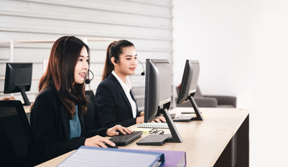 Young business staff asian woman working with headphone and computer for support.