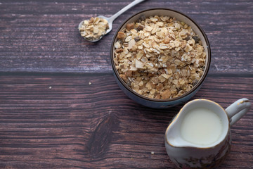 top view of oats in a bowl with milk on table 
