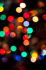 Colorful Christmas bokeh lights on a dark background