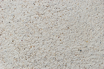 A grunge texture background of an old  stone relief wall with small spots