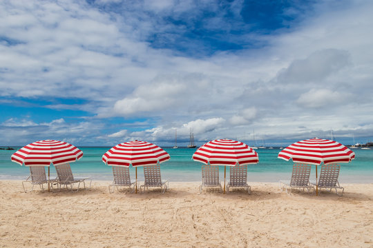 Red Beach Chairs, Umbrellas And Ocean View