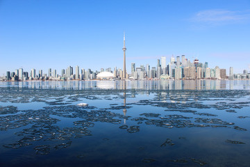 Panorama city skyline on frozen ice lake on sunny day