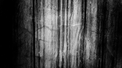 abstract grunge cement wall with faded paint. use as a background or wallpaper. black and white, so contrast and grainy.