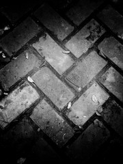 Abstract grunge paving stone texture. use as a background or wallpaper. black and white, so contrast and grainy.