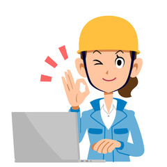 OKのサインを出してパソコンを操作する建設業の女性　青い服