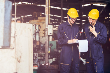 Group of industrial factory maintenance engineers inspect relay protection system using walkie...