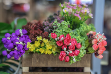 Fototapeta na wymiar Different artificial flowers. Colorful artificial flower decorations. Selective focus