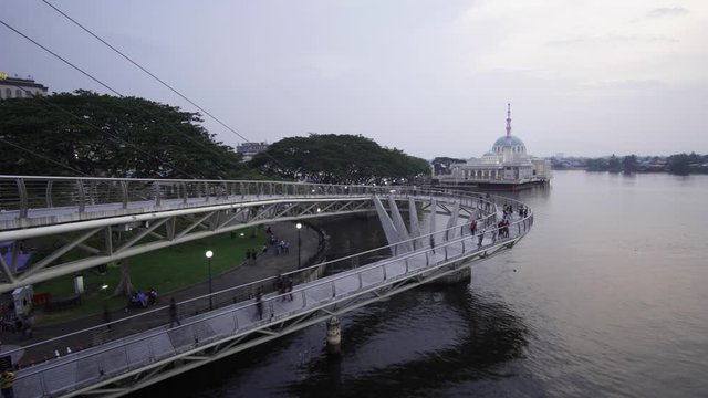 footage time lapse people at darul hana bridge with background mosque 