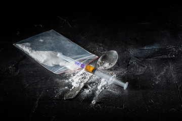 Drug white powder sprinkled on dark background. Drug use and prohibited substances