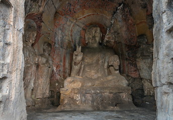 Buddha statue carved inside a cave. Early Northern Wei style grotto at Longmen Grottoes, Henan...