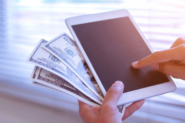 Businessman with cash dollars - business concept,tablet and finance,investment,save,success and profitable business concepts.